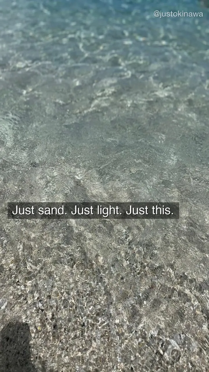Water’s edge at Zamami Island — shallow crystal clear ocean meeting white sand shore