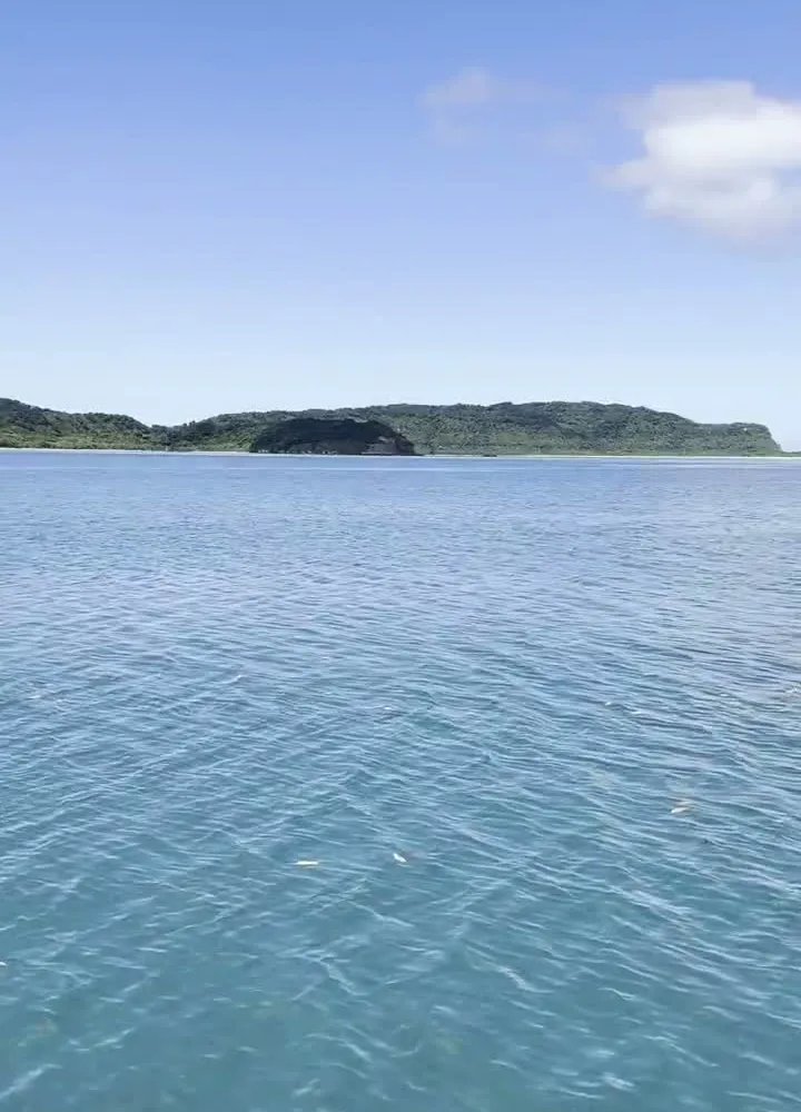 Hidden beach in Okinawa with no signs and no people — crystal clear water and empty sand on a quiet stretch of coastline